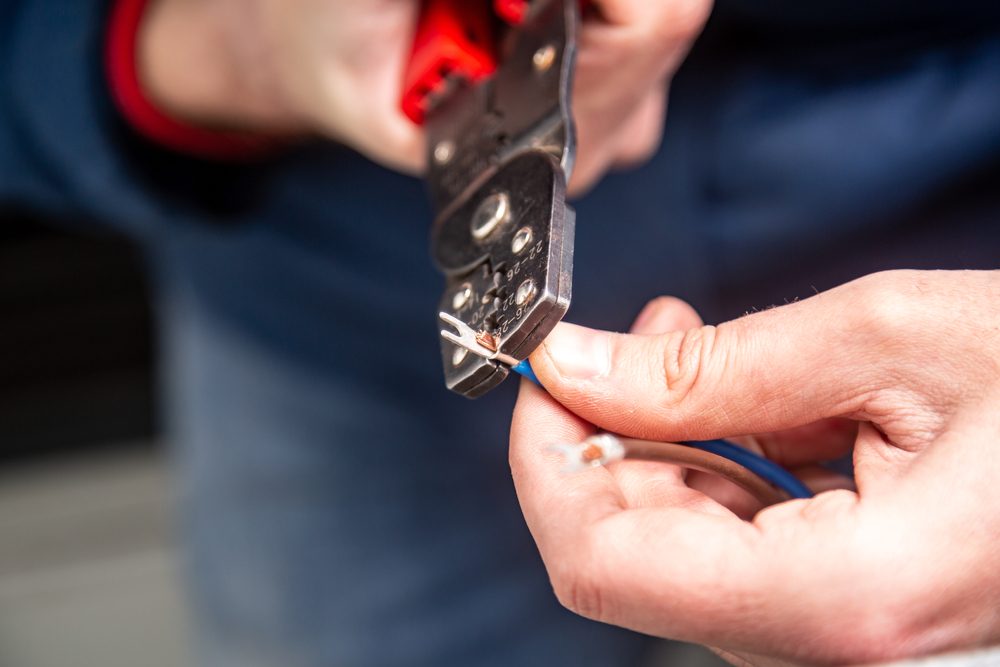 Person crimping a wire