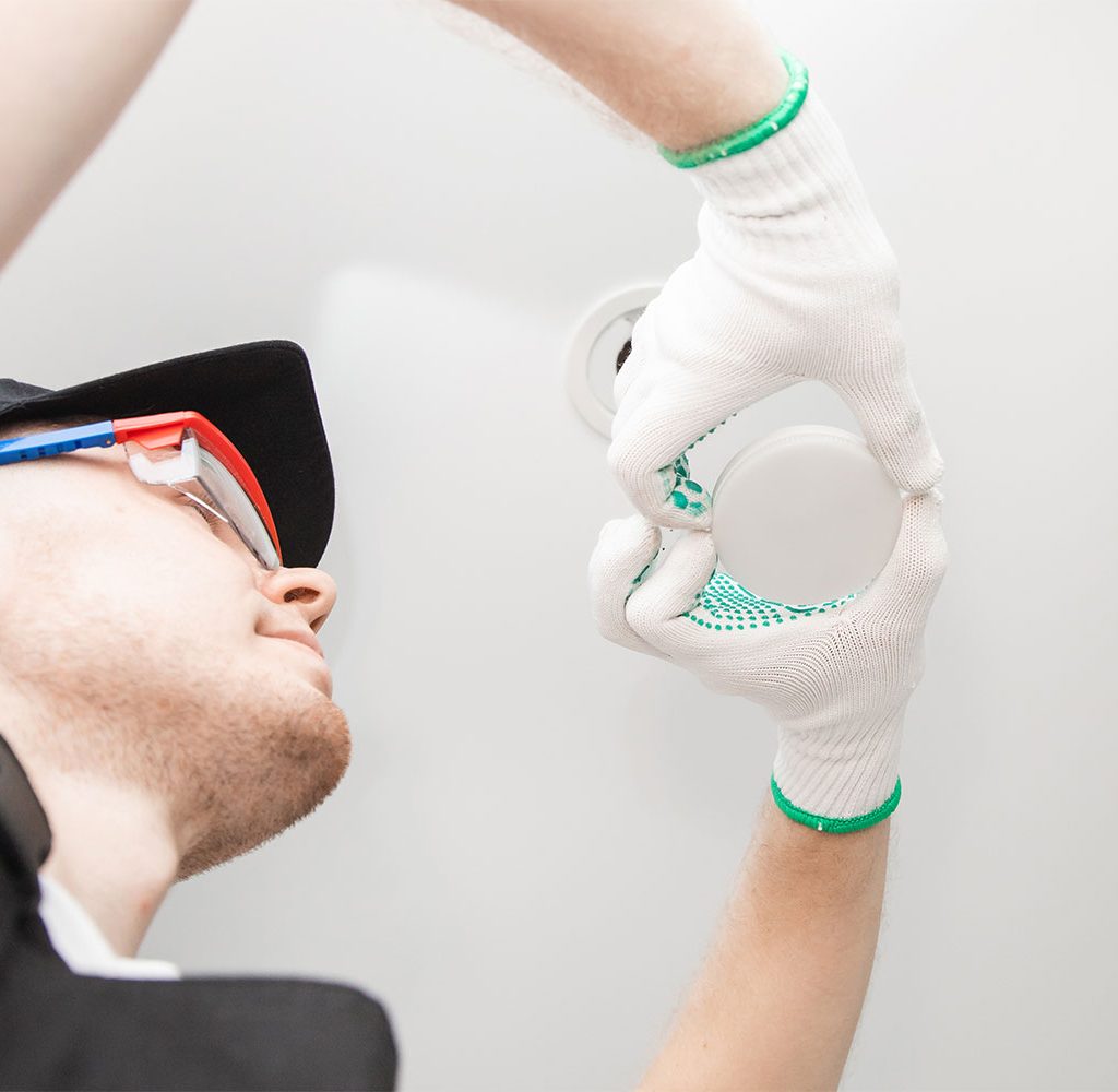 electrician changing lightbulb