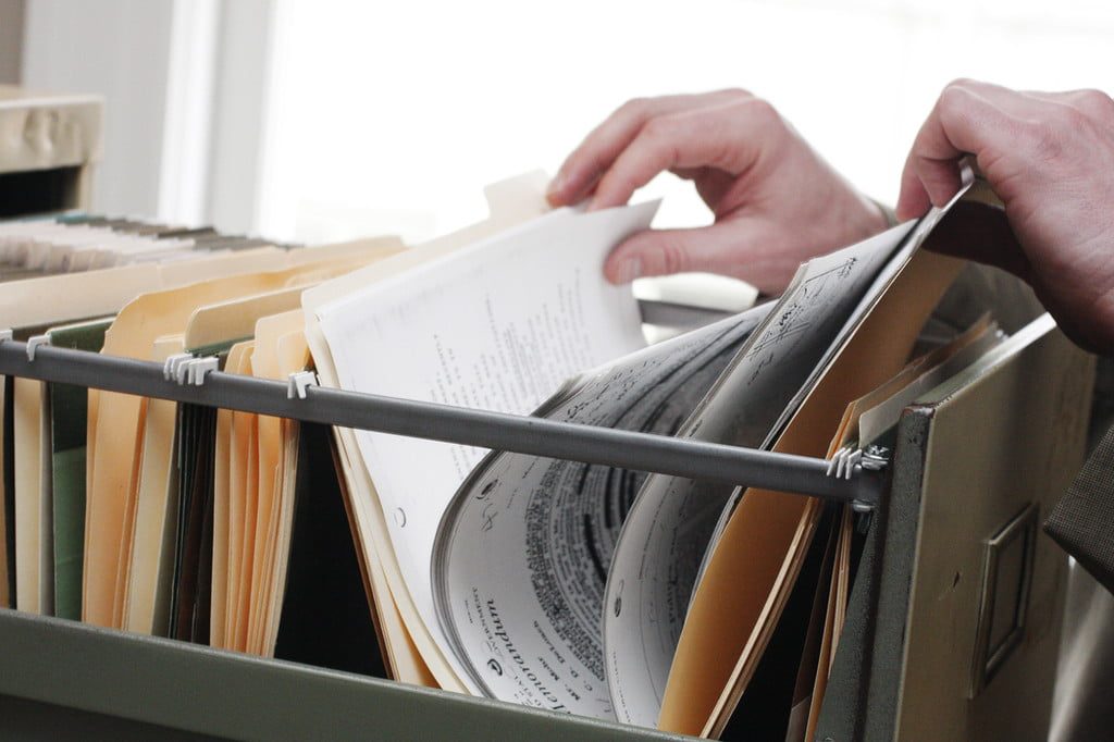 Person looking at papers in filing cabinet