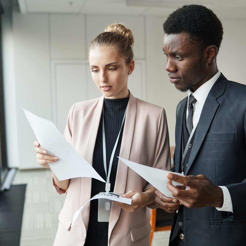 Business Couple Standing With Documents