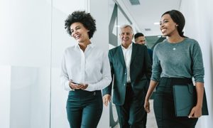 Smiling coworkers in an office hallway