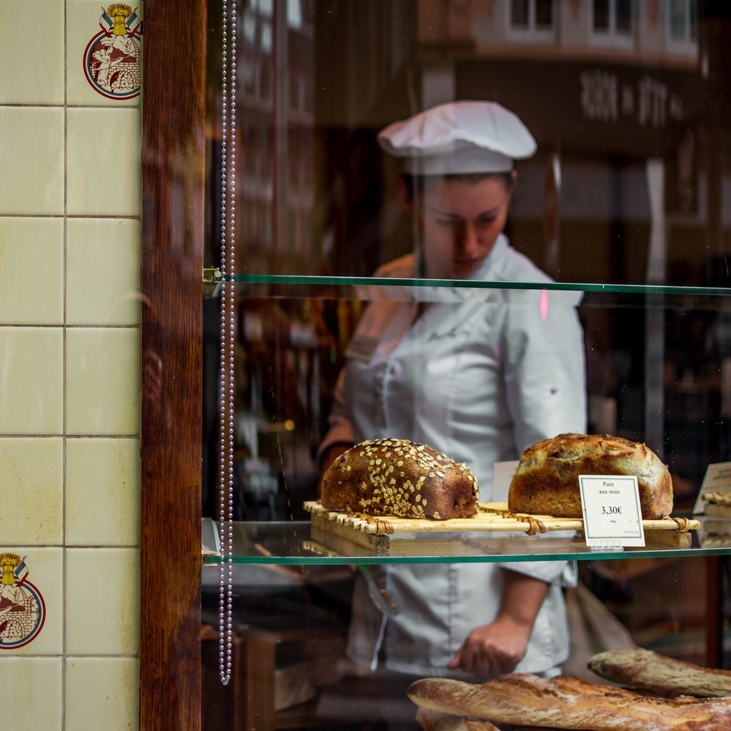 Macro Shot Photography of Bread Near Chef