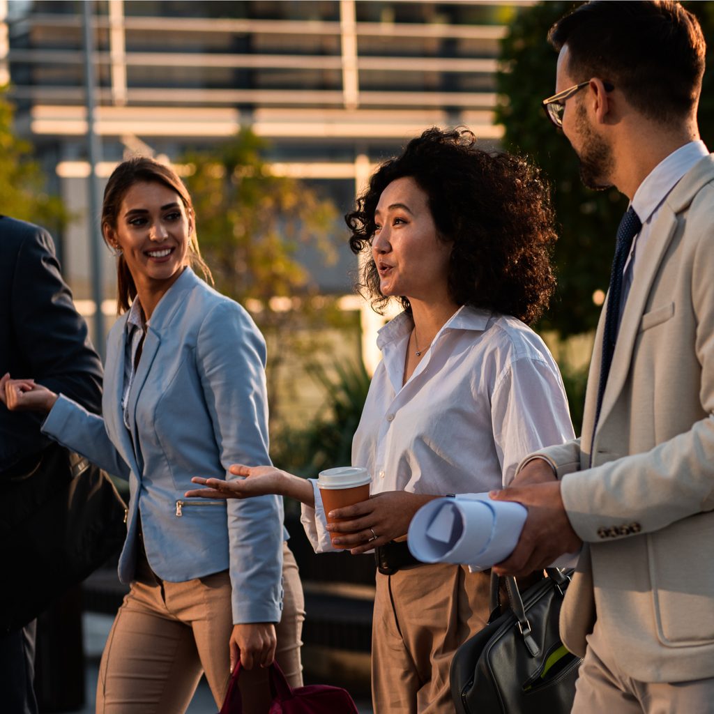 Four business professionals walking together