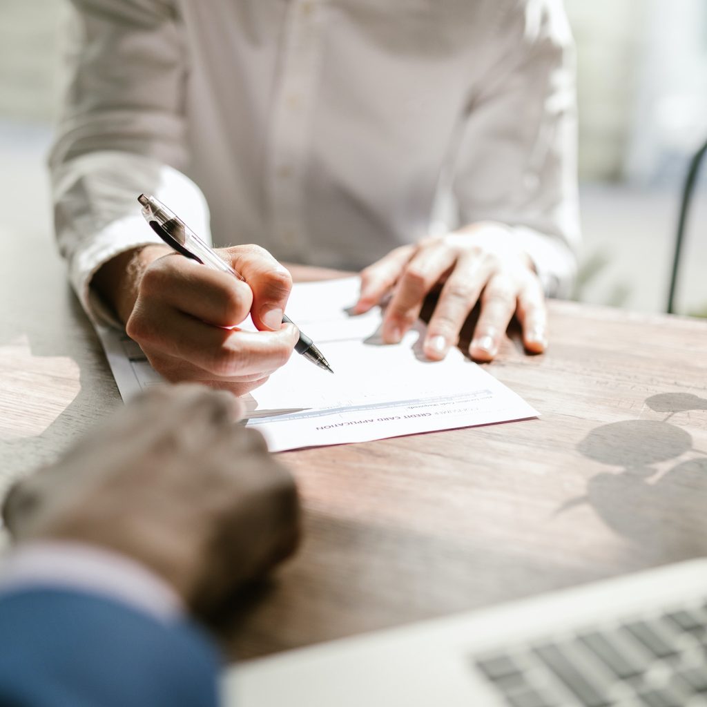 Person writing on white paper
