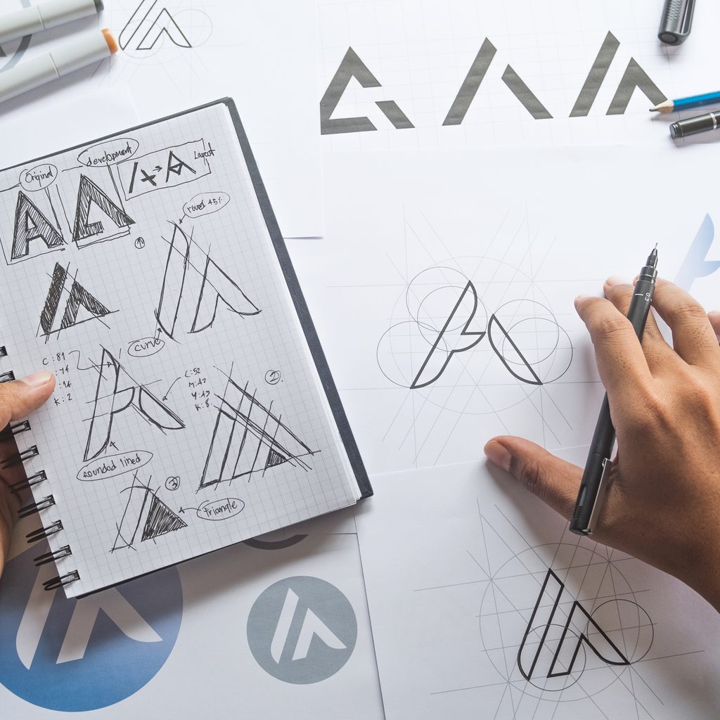 Hands Drawing Logo Sketches