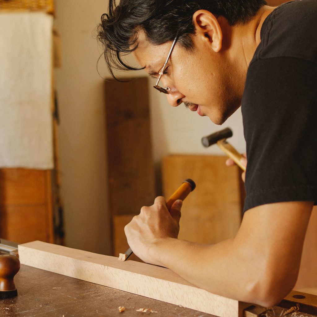 Man using a chisel on wood