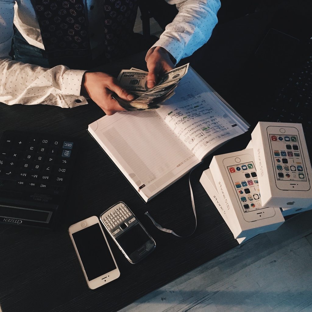 Businessperson counting money on a table
