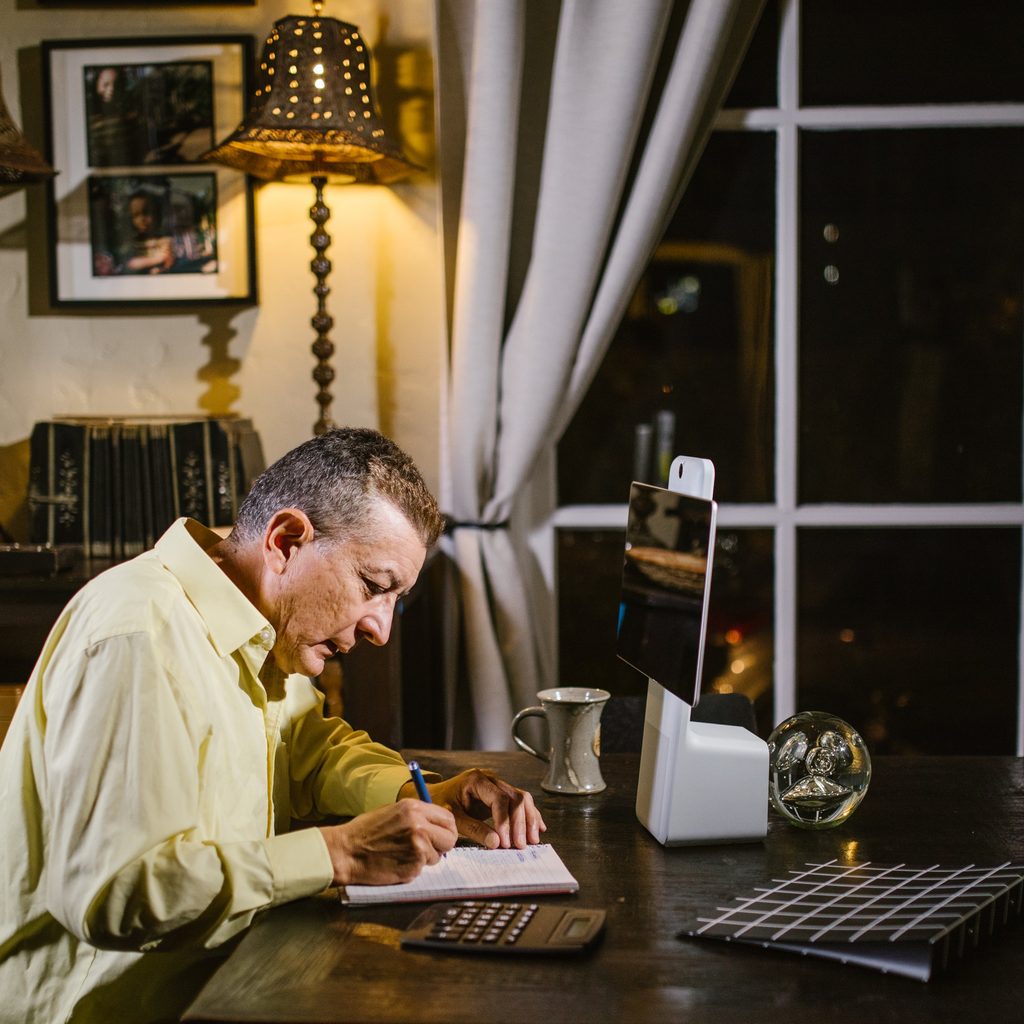 Man Writing In Notebook
