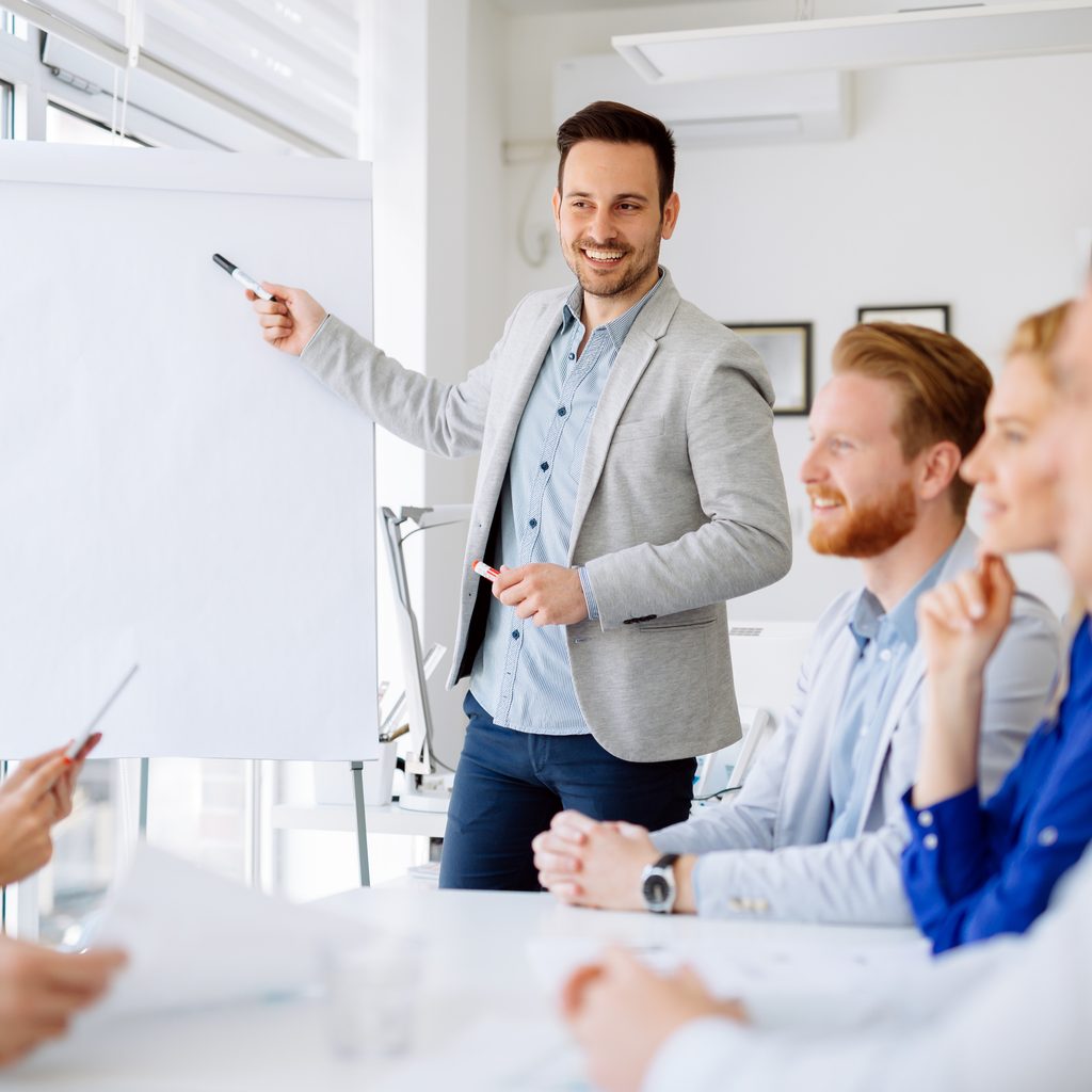 Man smiling and giving presentation