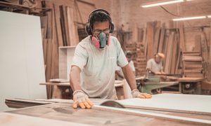 Carpenter working with wood in woodshop