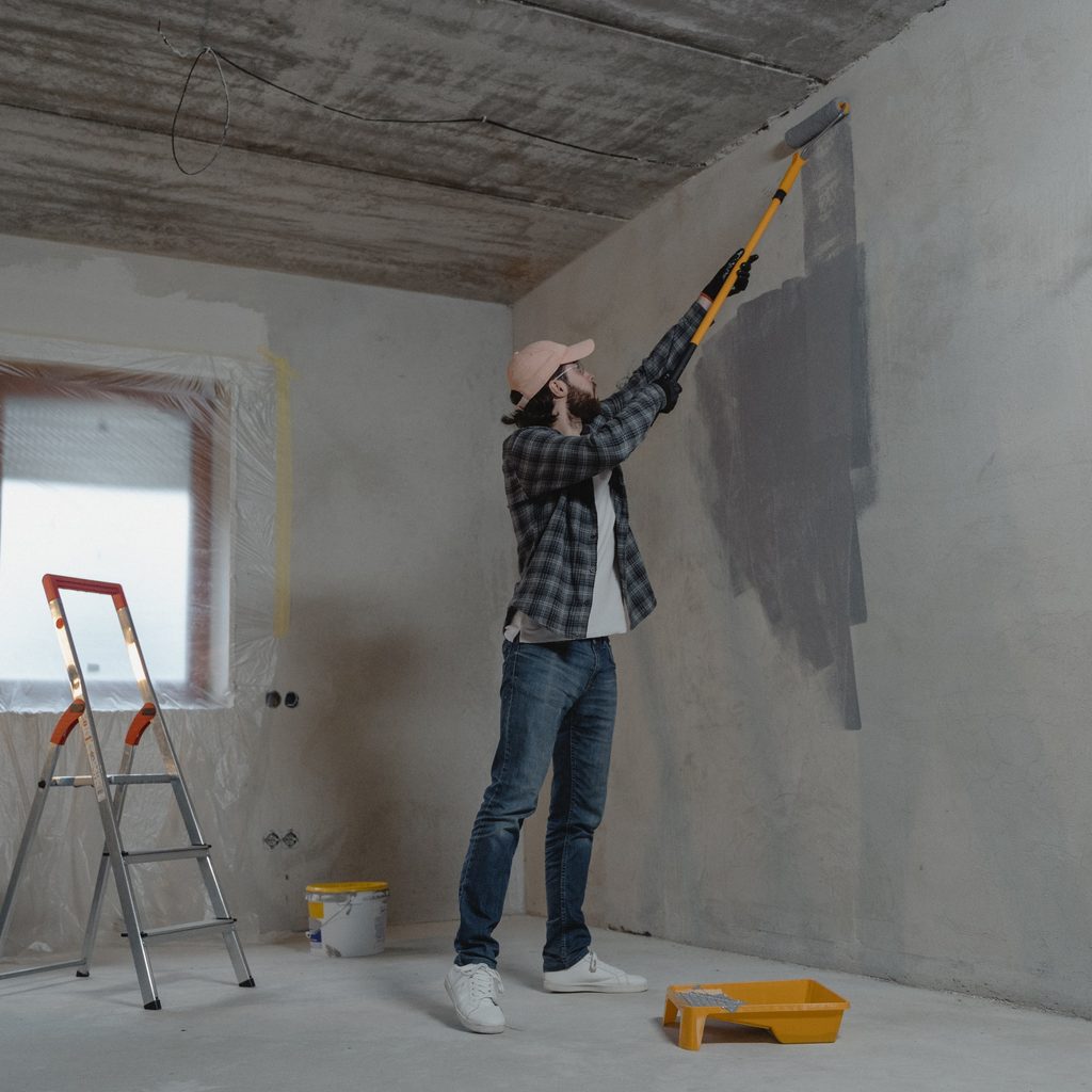 Sub contractor painting a wall