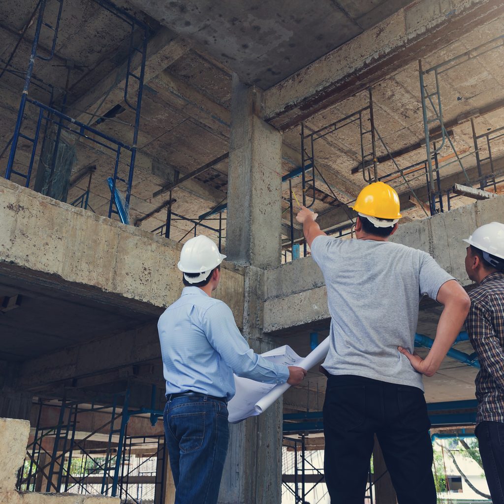 Construction manager talking to architects in building