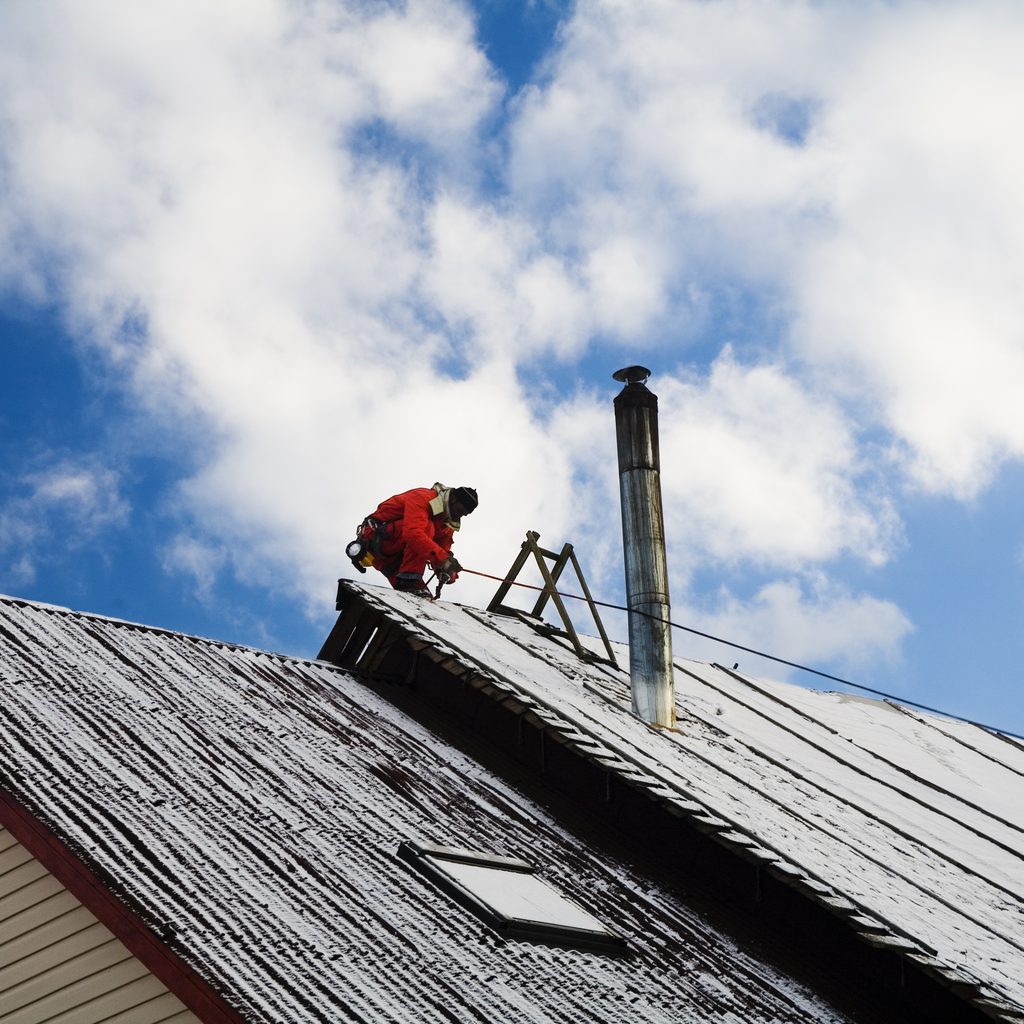 Man Working On Steep Roof