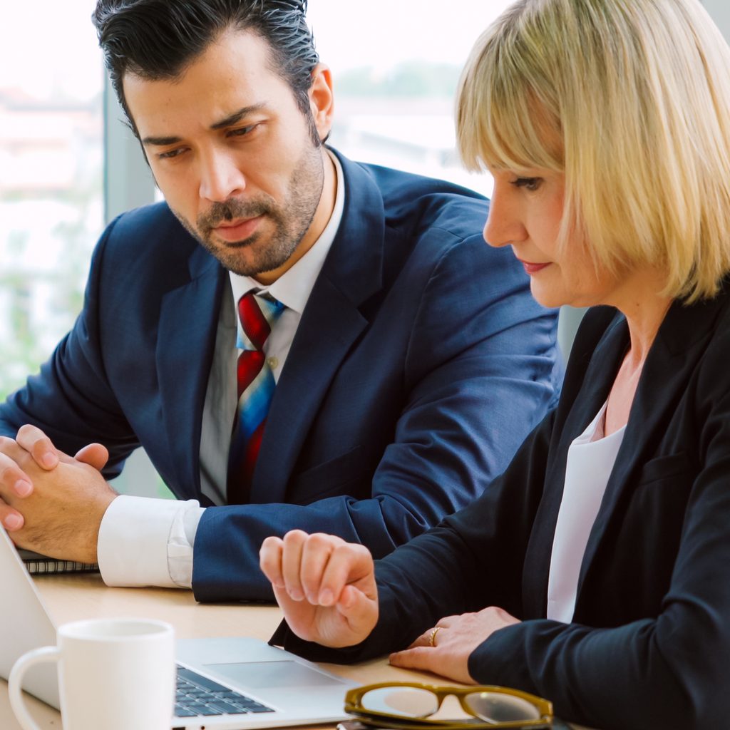 Two business people talk project strategy