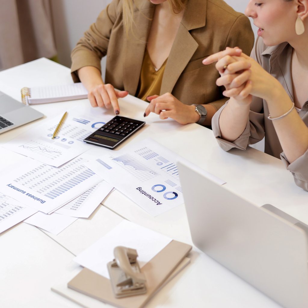 Two women calculating business funds