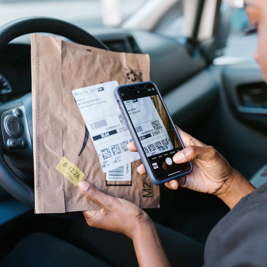 Female Uber driver checking delivery order