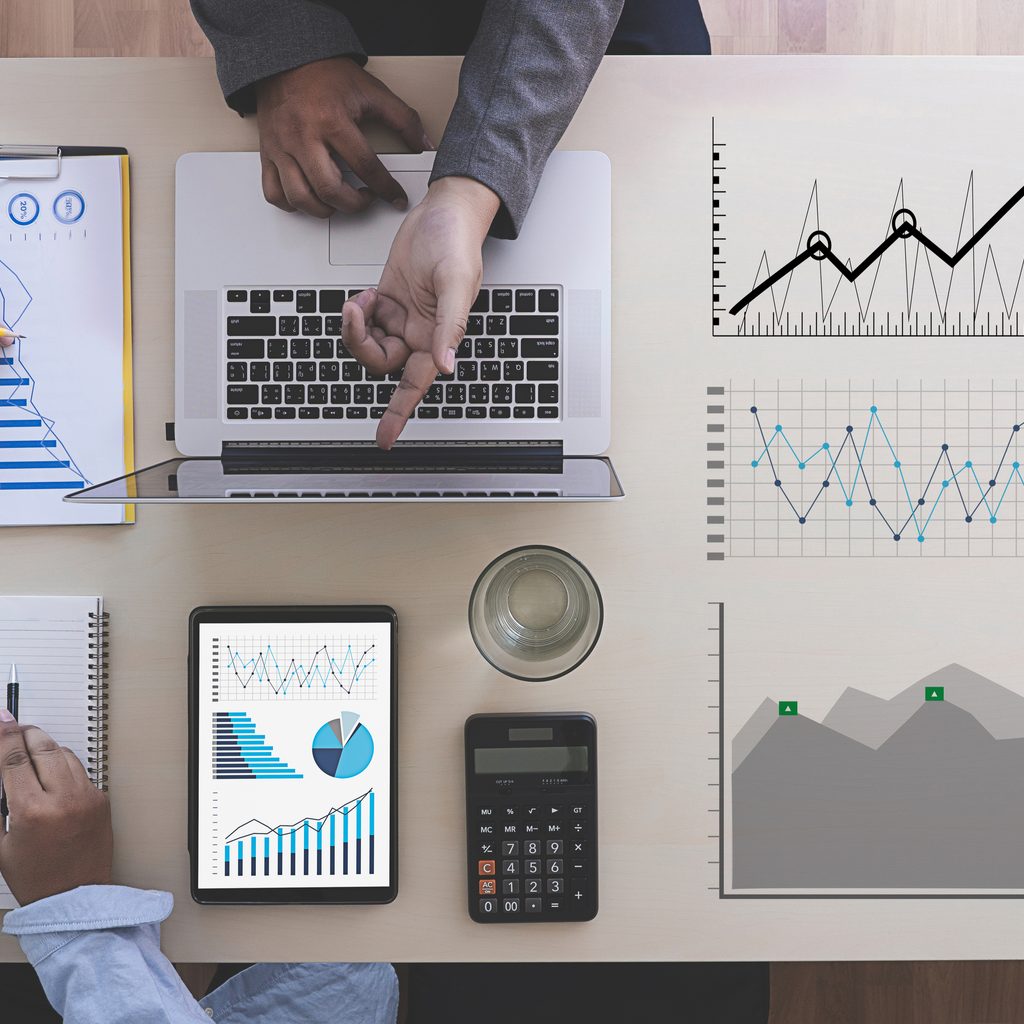 Man pointing toward market research graphics