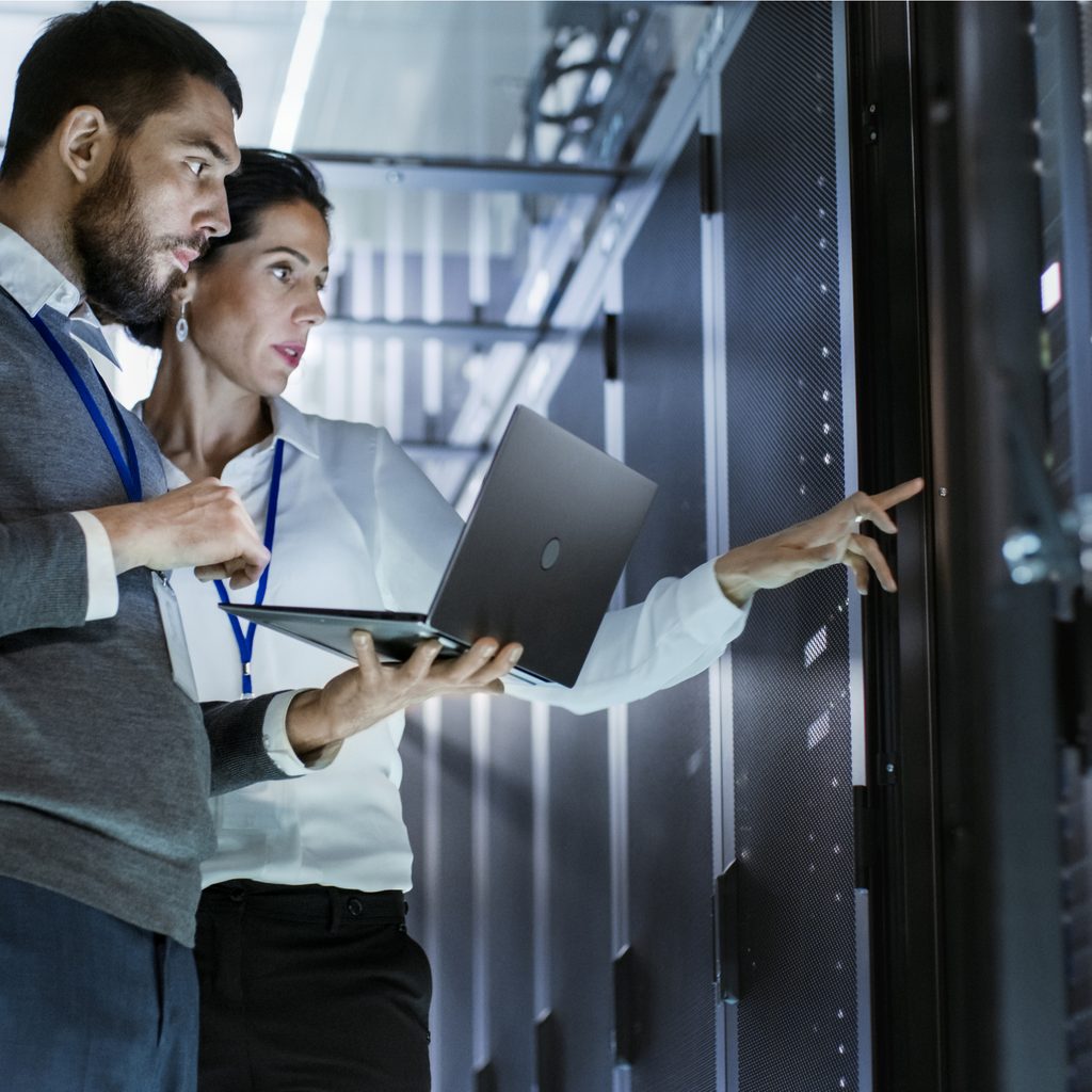 Man and woman working in data center