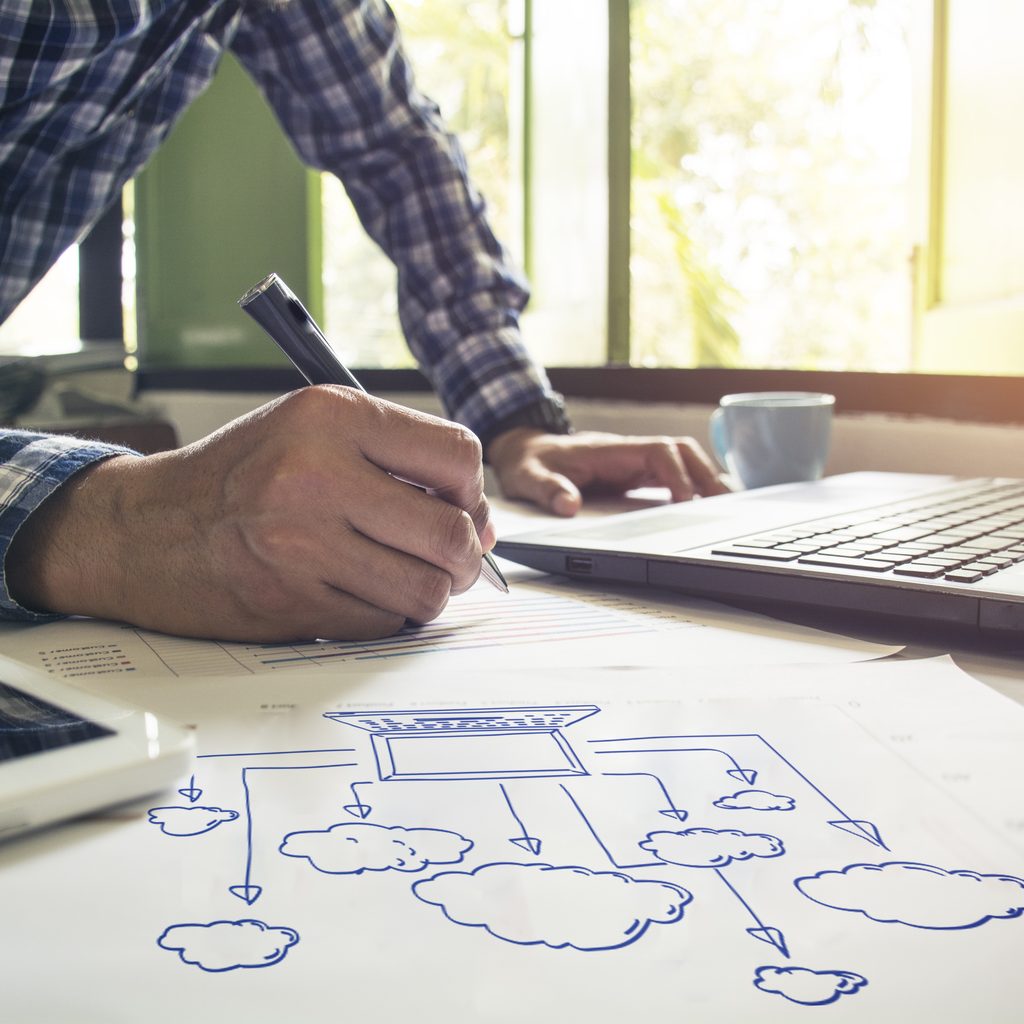 Man working on drawing of cloud concepts