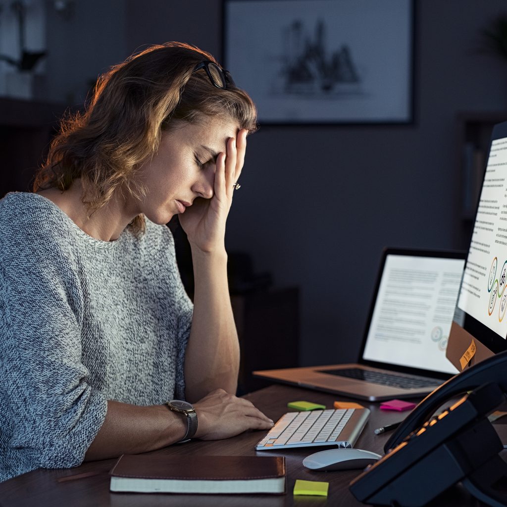 Businesswoman suffering from overwhelm