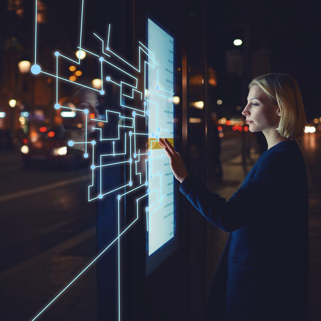 Blonde woman touches a smart screen