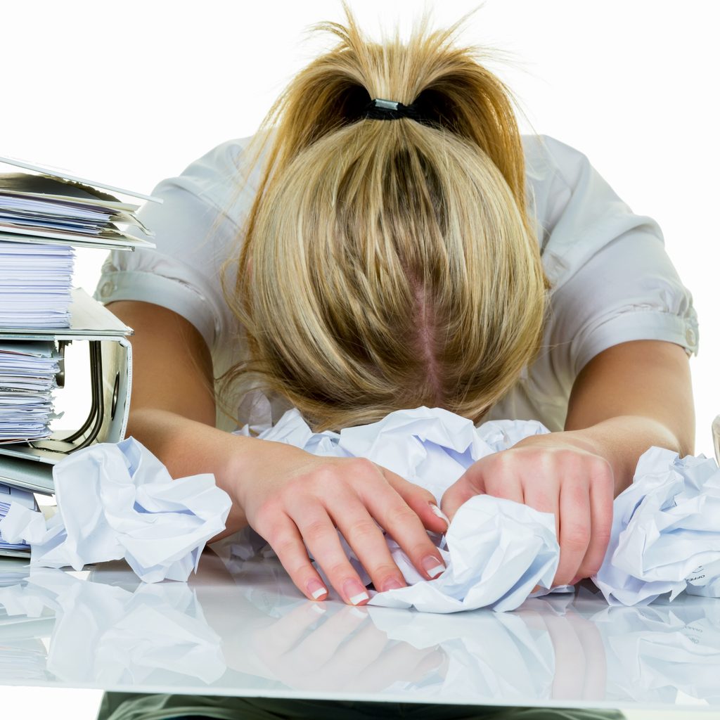 Young woman with her head on desk
