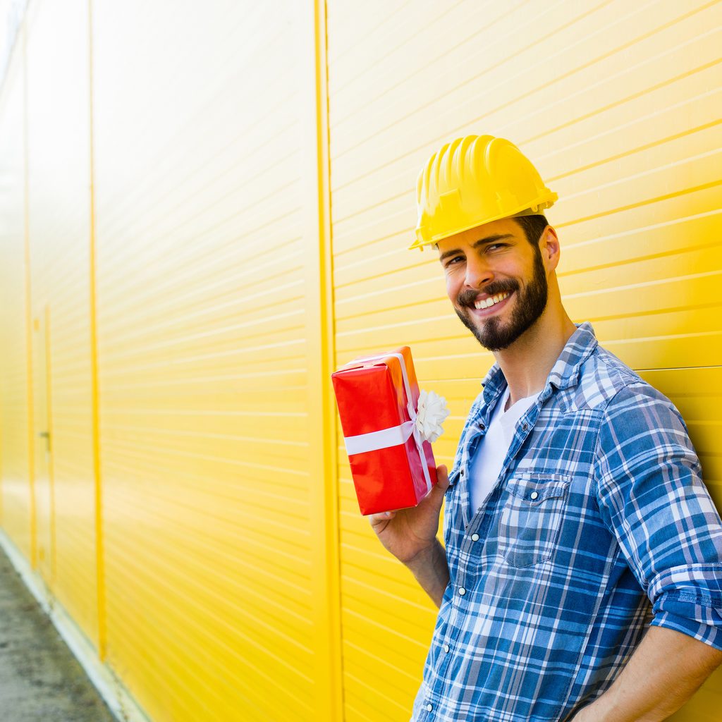 Happy contractor holding a gift