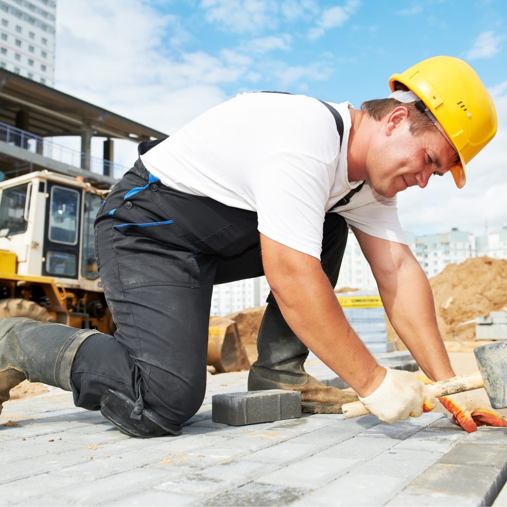 Construction worker hammering nails