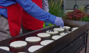 griddle pancake two cooks with gloves and red aprons