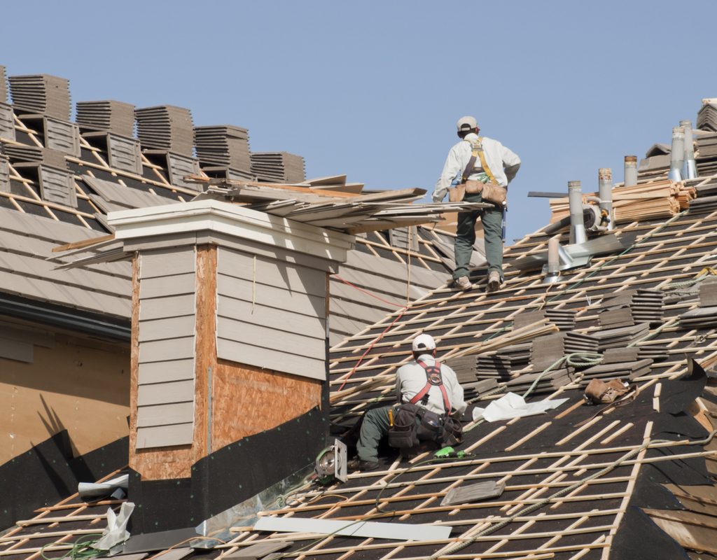 Workers replacing a roof