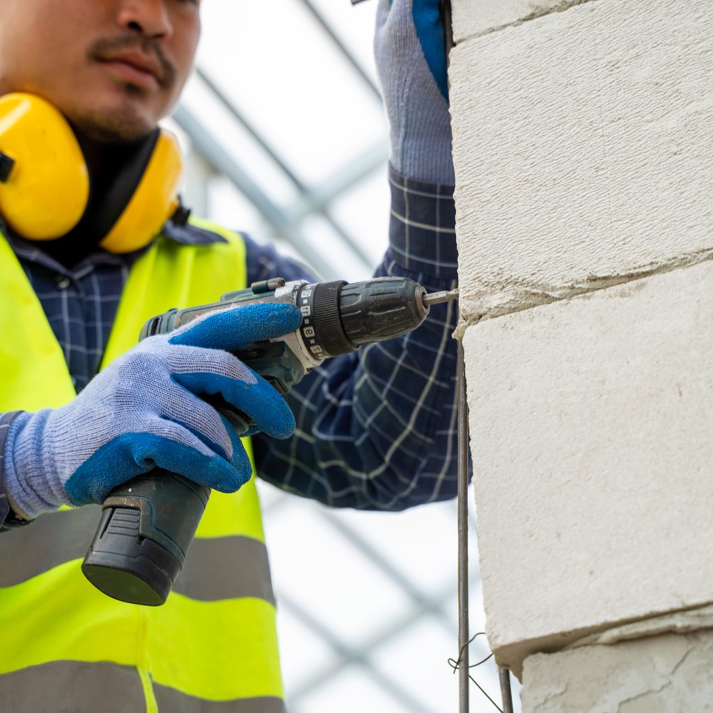 Contractor using a cordless drill