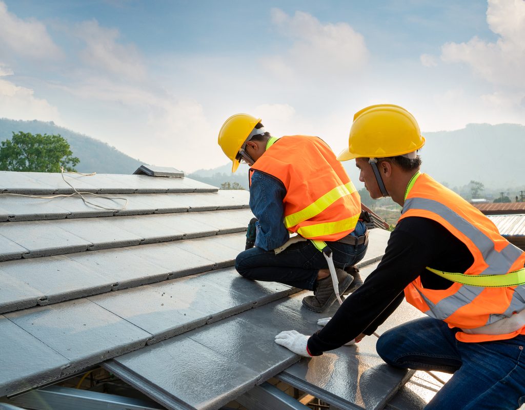 Workers installing a metal roof
