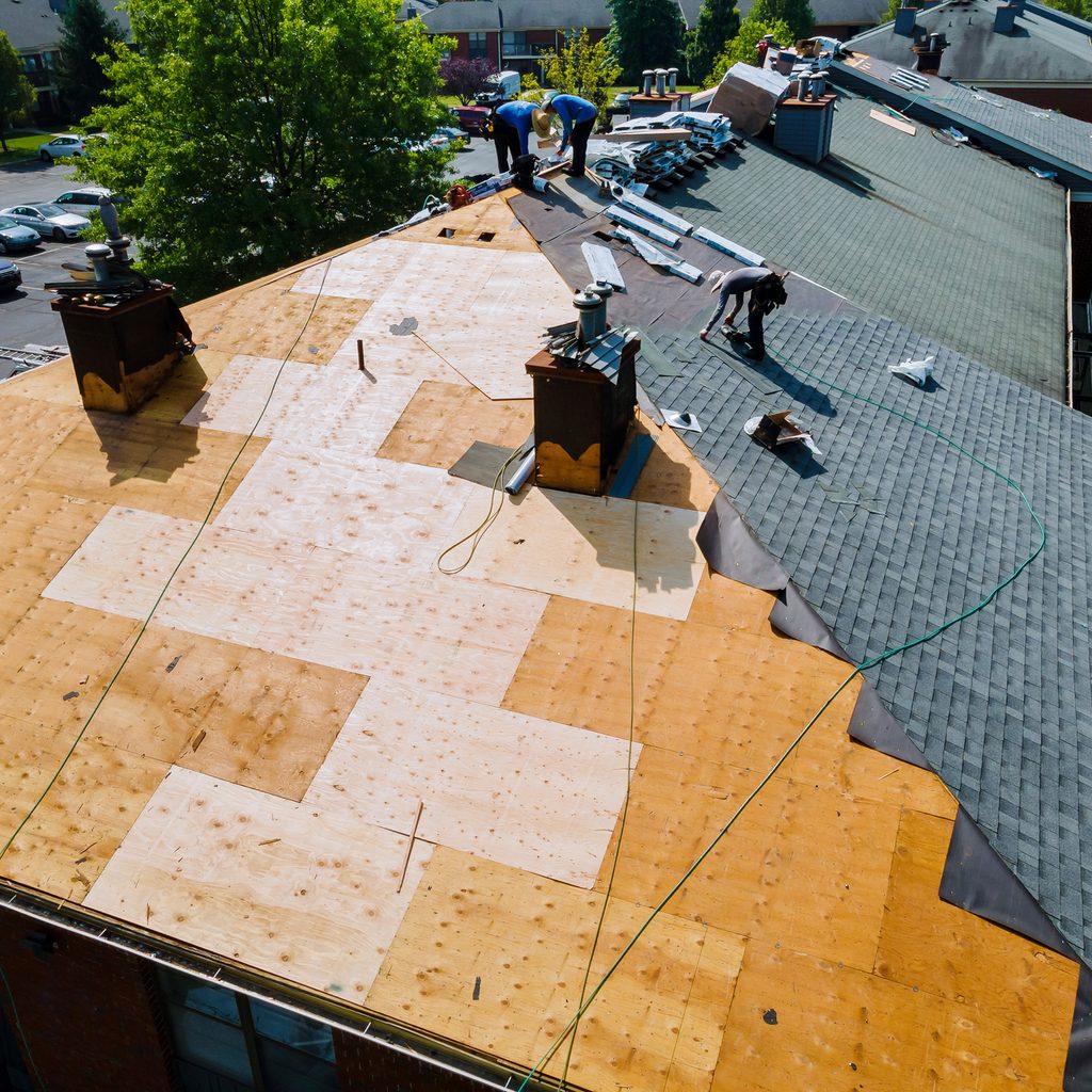 Workers replacing a roof