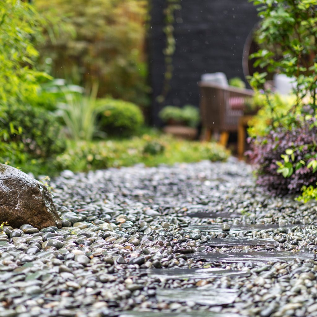 Decorative sprinkling of flowerbed paths with pebbles