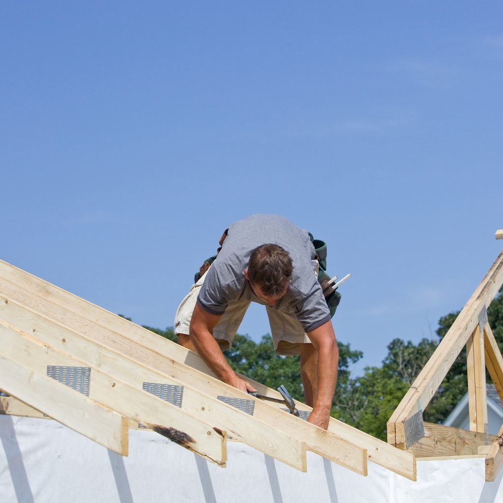 Worker building a roof truss