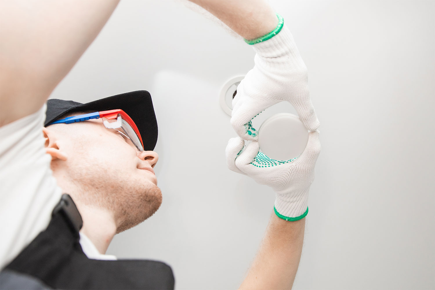 electrician changing lightbulb