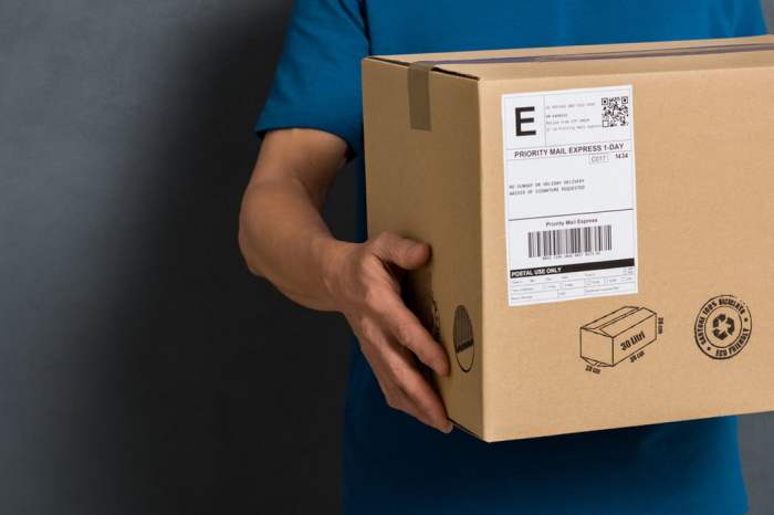 Person holding a labeled package