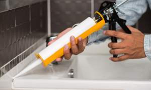 Person using caulk gun