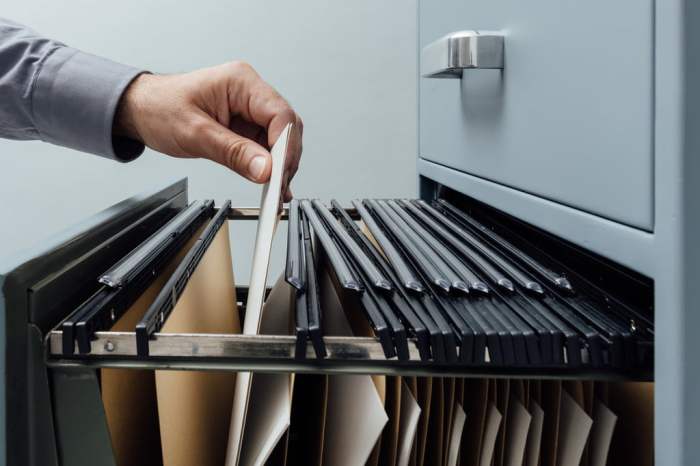 Individual going through file cabinet