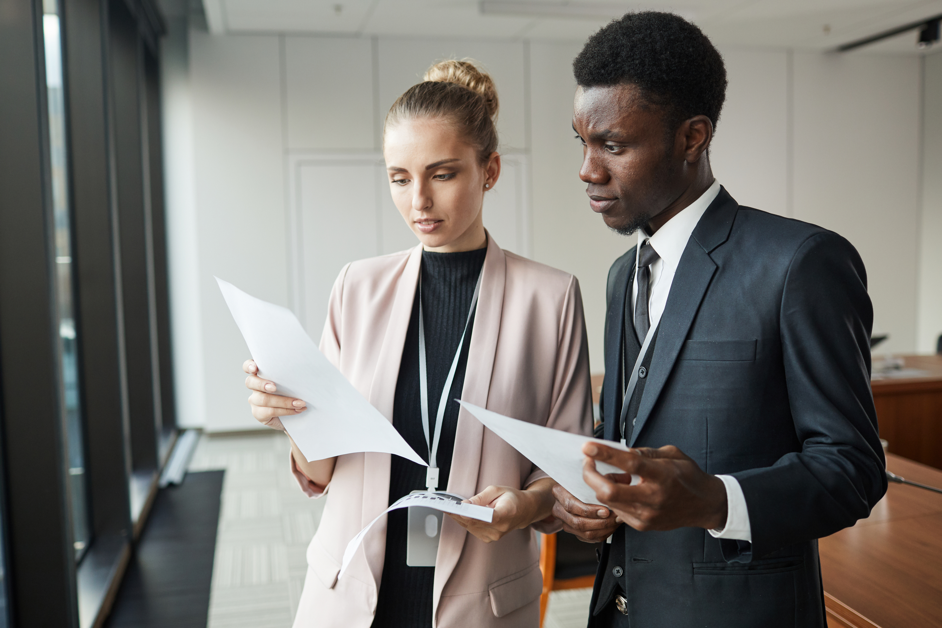 Business Couple Standing With Documents