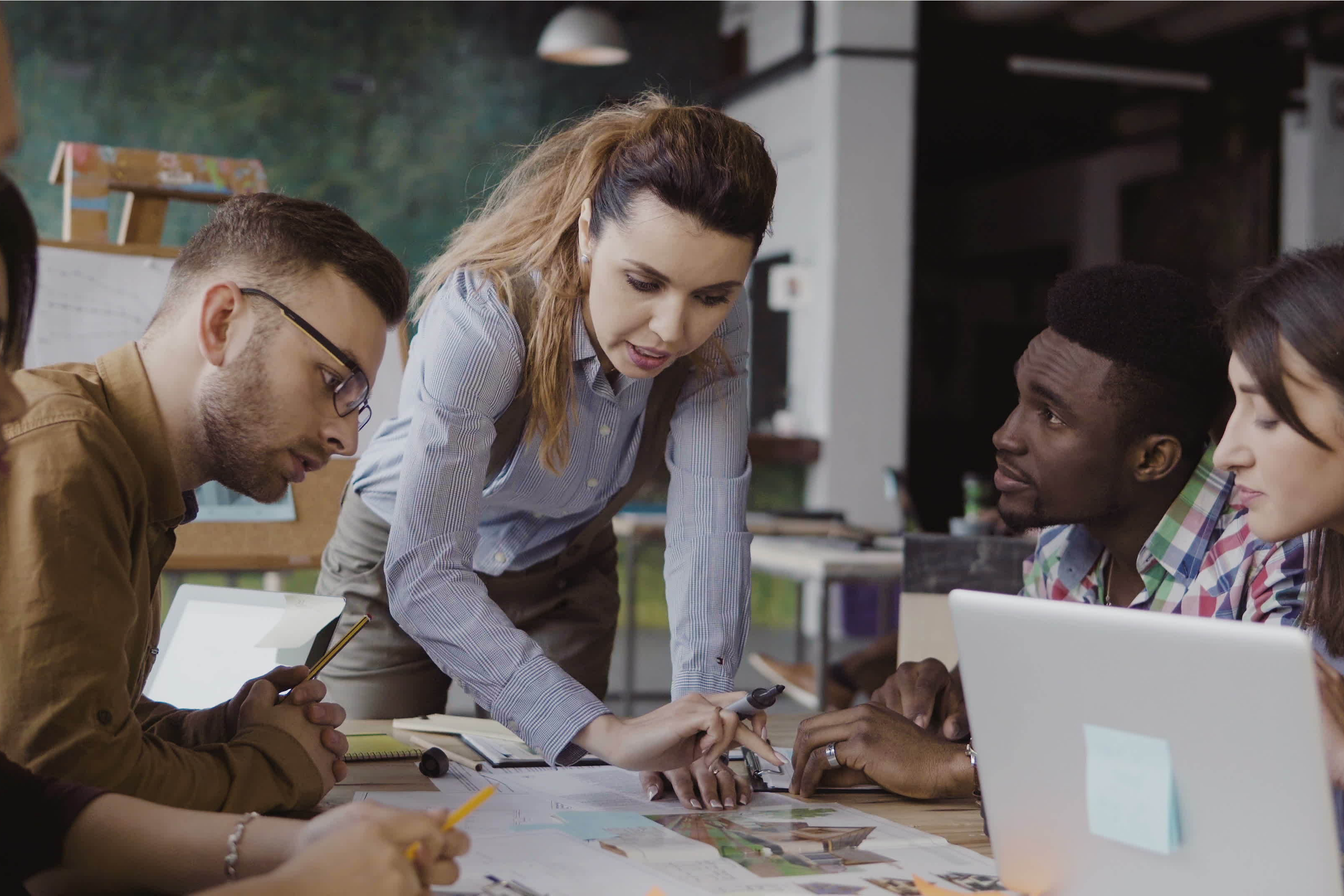 Female Business Leader Speaking To Employees