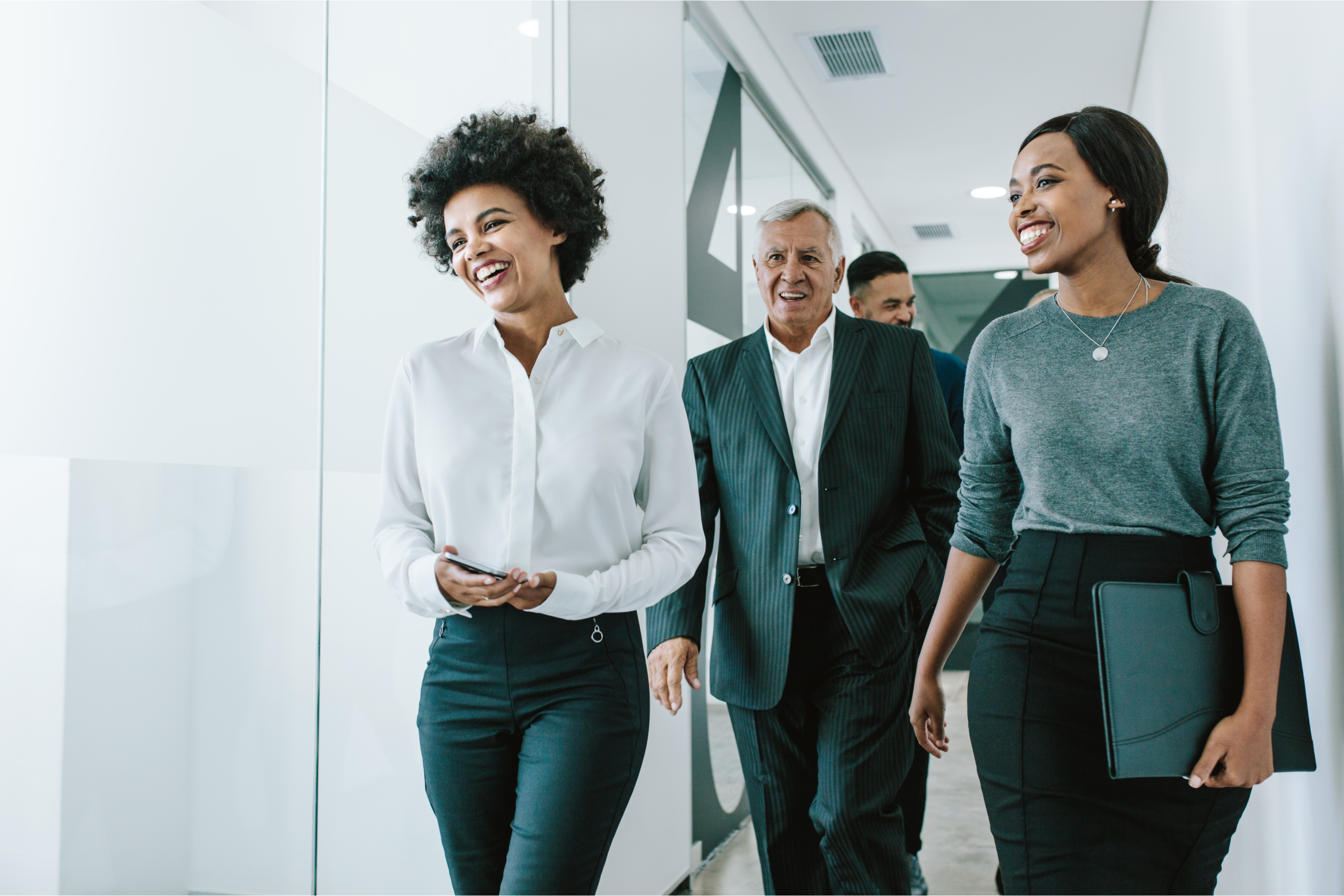 Smiling coworkers in an office hallway