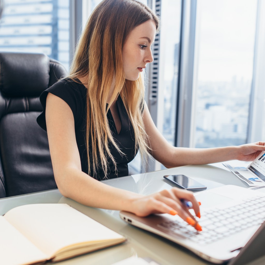 Female receptionist working at desk