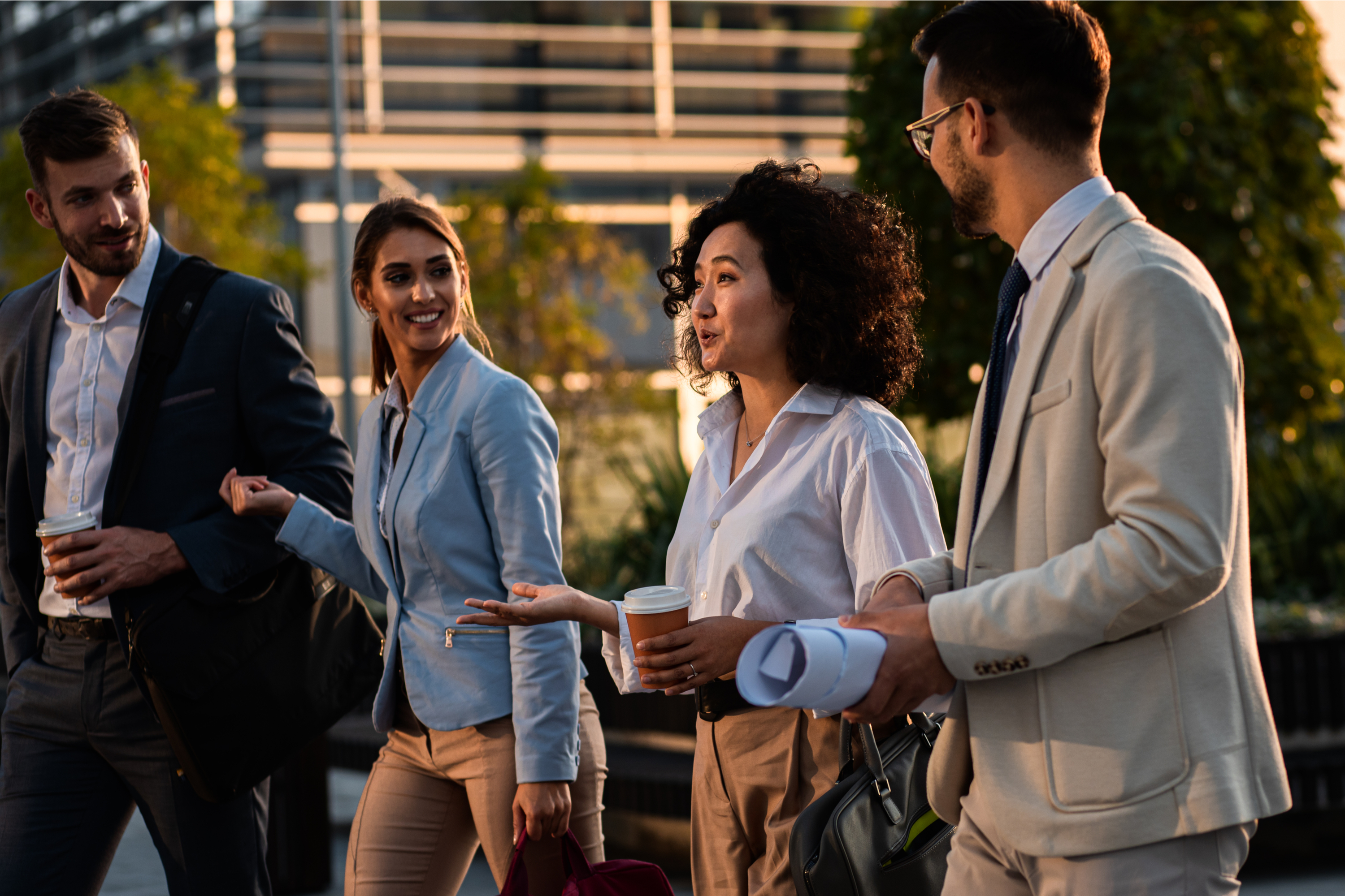 Four business professionals walking together
