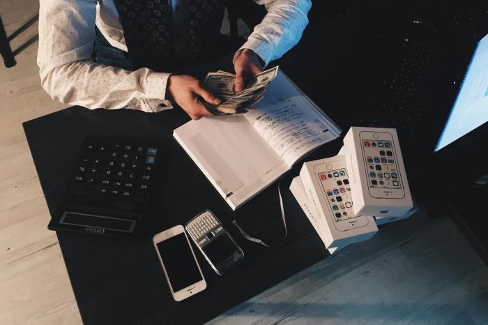 Businessperson counting money on a table