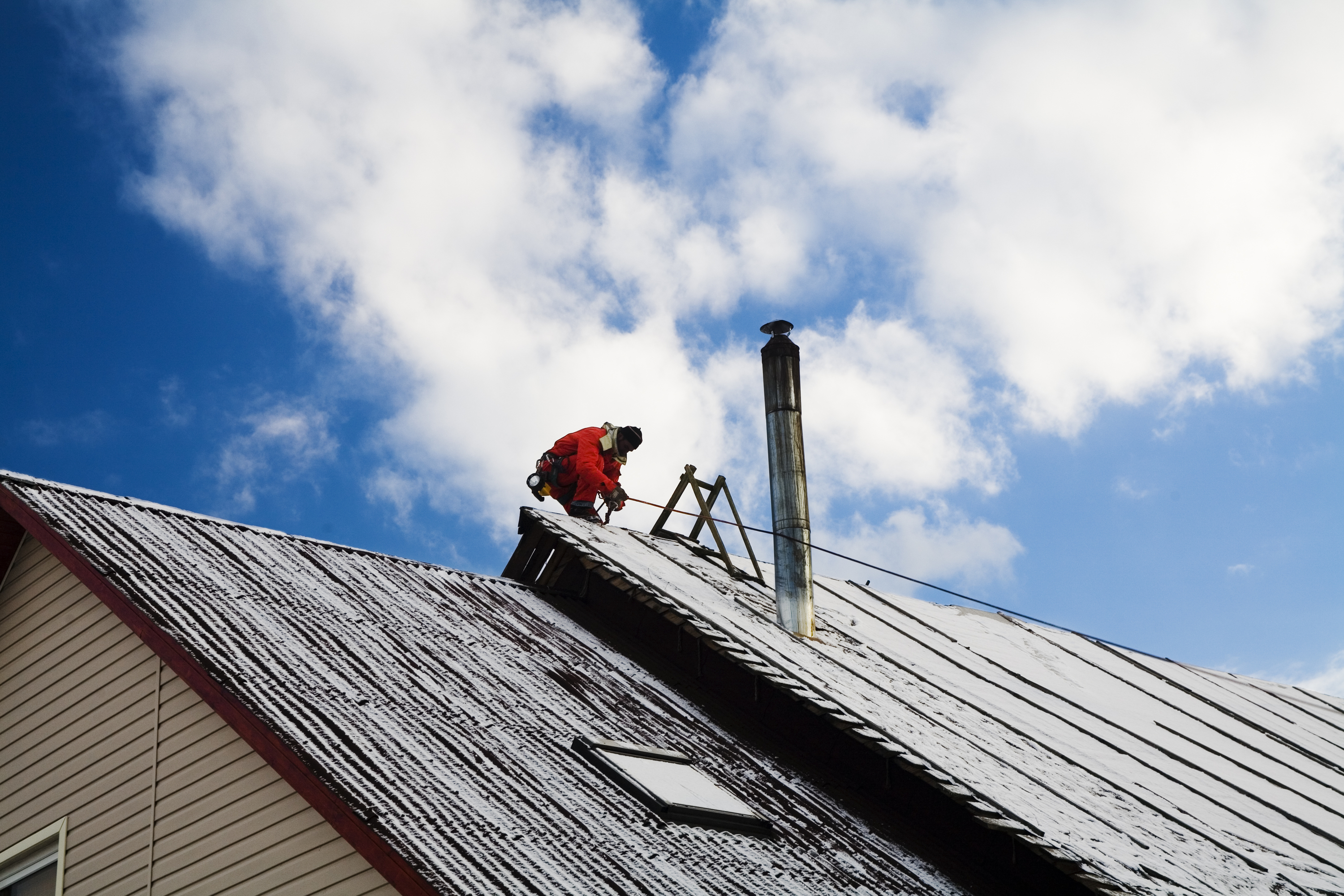Man Working On Steep Roof