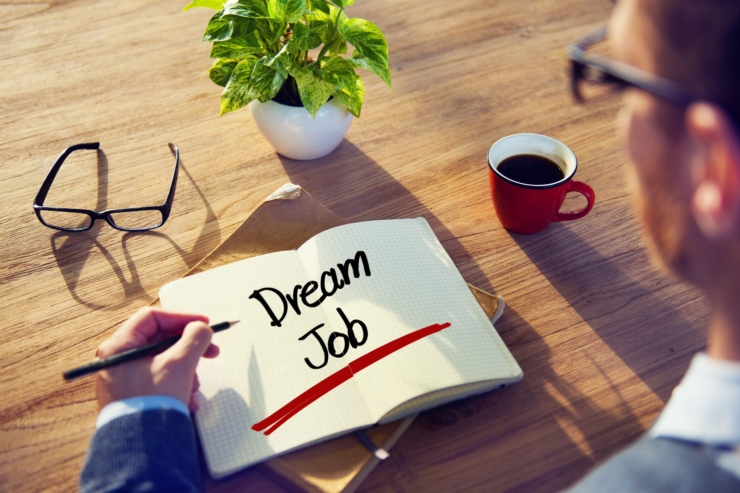 Business man writing in notebook