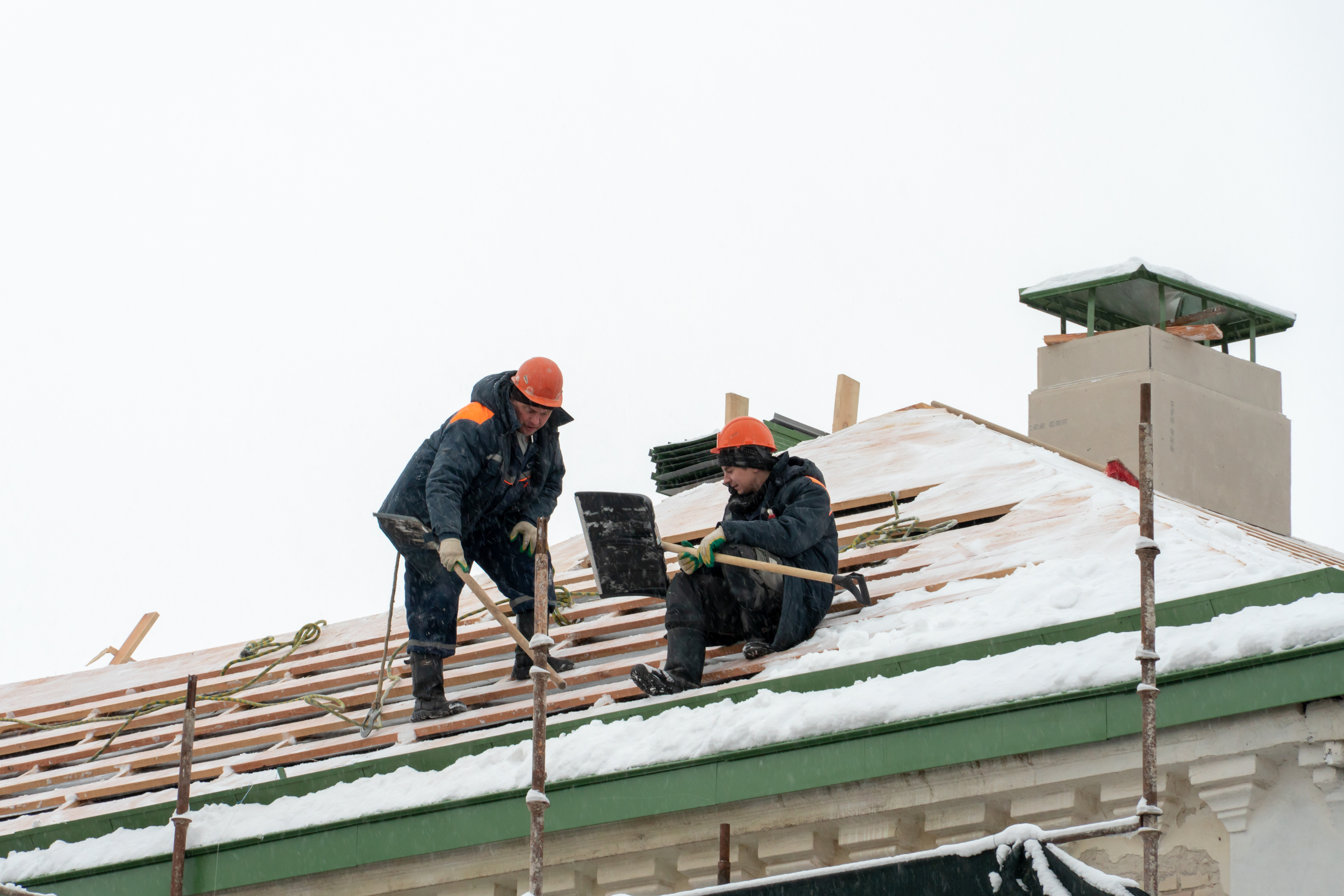 Roofers working on roof in winter