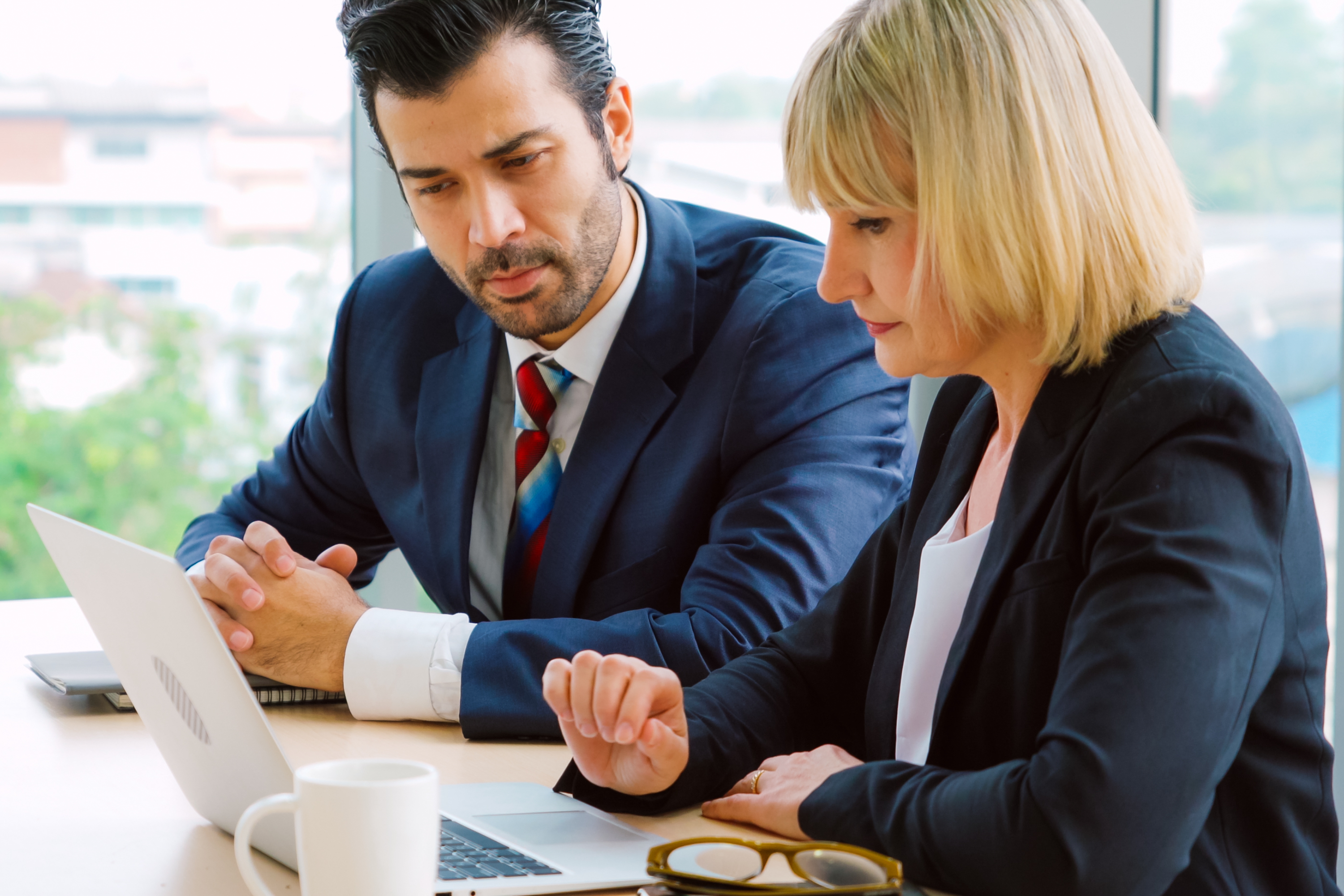 Two business people talk project strategy