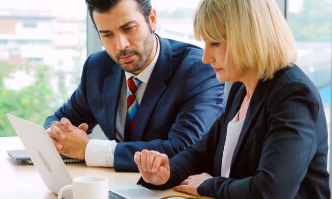 Two business people talk project strategy